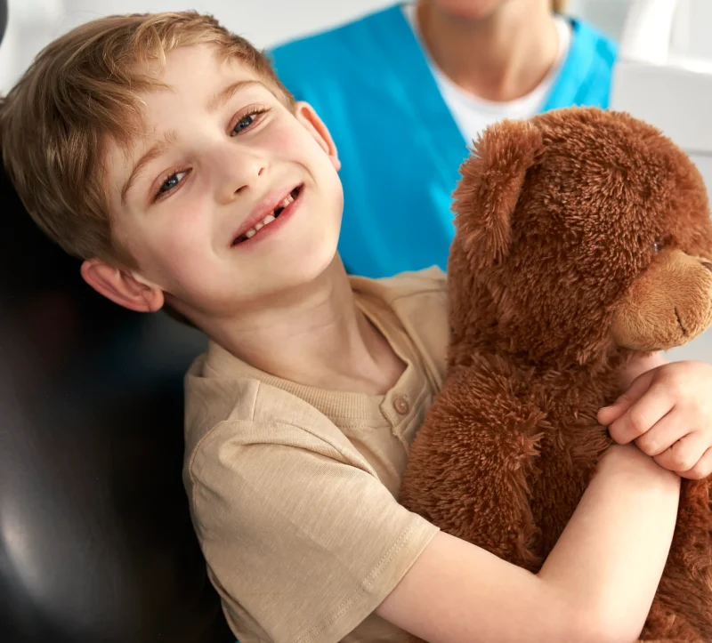 Child smiling and relaxed in dental chair at Germantown Pediatric Dental Center